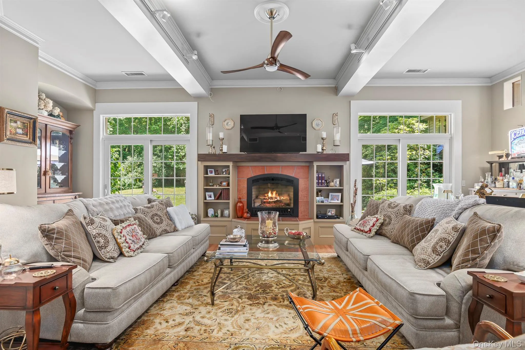 The great room/family room has a fireplace, high ceilings & two sets of French doors out to the stone patio & back yard The great room/family room has a fireplace, high ceilings & two sets of French doors out to the stone patio & back yard