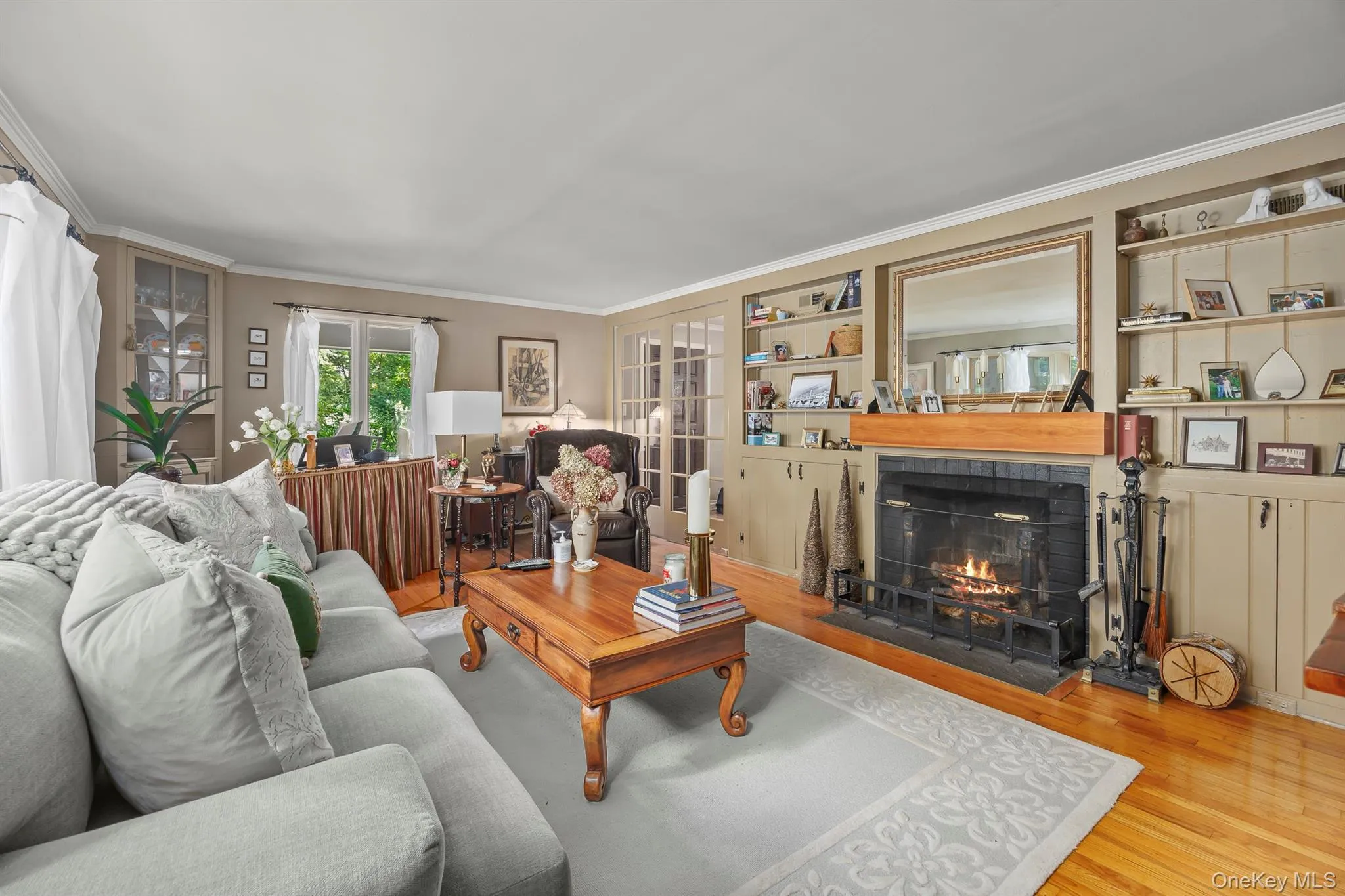 The lovely living room with built-ins and fireplace is cozy and elegant The lovely living room with built-ins and fireplace is cozy and elegant