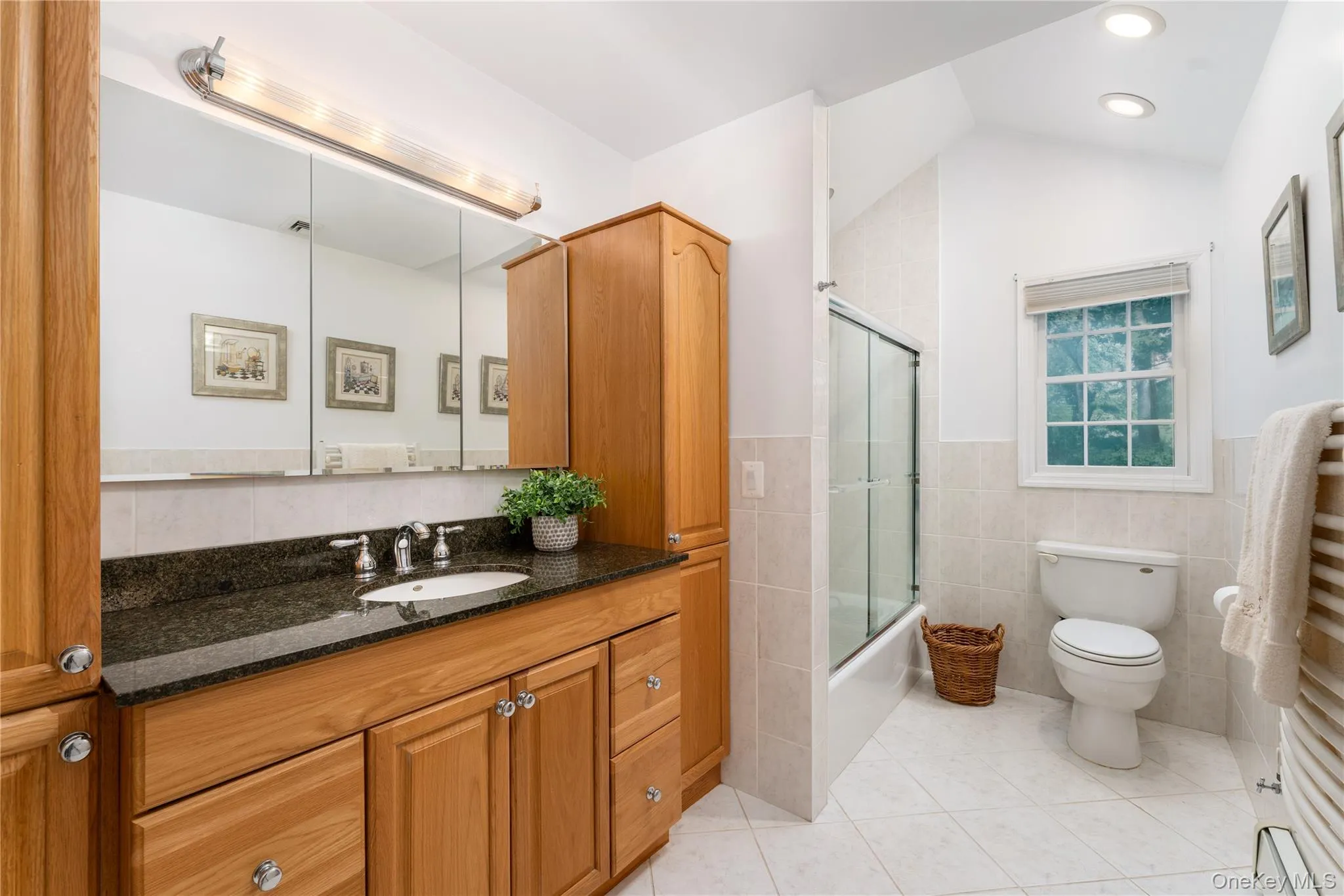 Full hallway bathroom, vaulted ceiling, overhead light, custom vanity with tower storage, heated towel rack Full hallway bathroom, vaulted ceiling, overhead light, custom vanity with tower storage, heated towel rack