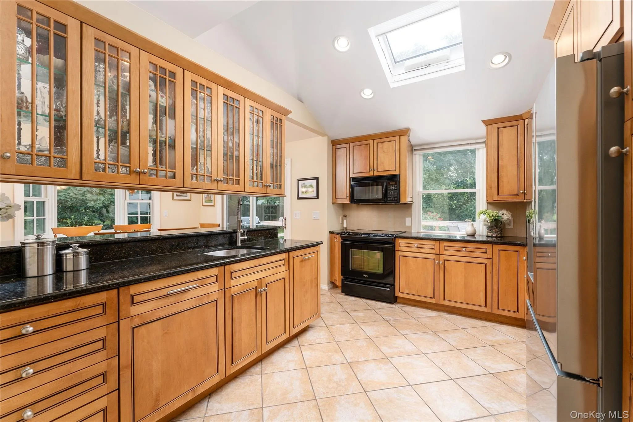 Custom hardwood cabinetry, granite counters, radiant heat floor, skylight, vaulted ceiling, accent lighting Custom hardwood cabinetry, granite counters, radiant heat floor, skylight, vaulted ceiling, accent lighting