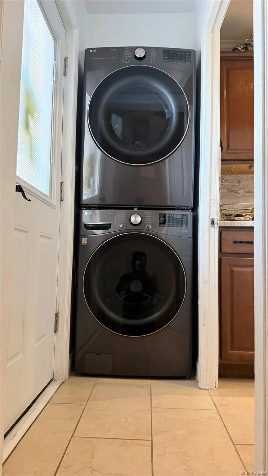 Stackable laundry appliances with front-loading design, set within a dedicated alcove Stackable laundry appliances with front-loading design, set within a dedicated alcove
