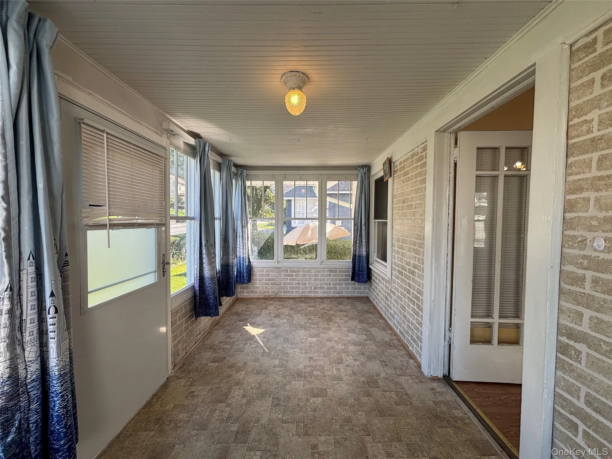 Bright enclosed sunroom with abundant natural light. Bright enclosed sunroom with abundant natural light.