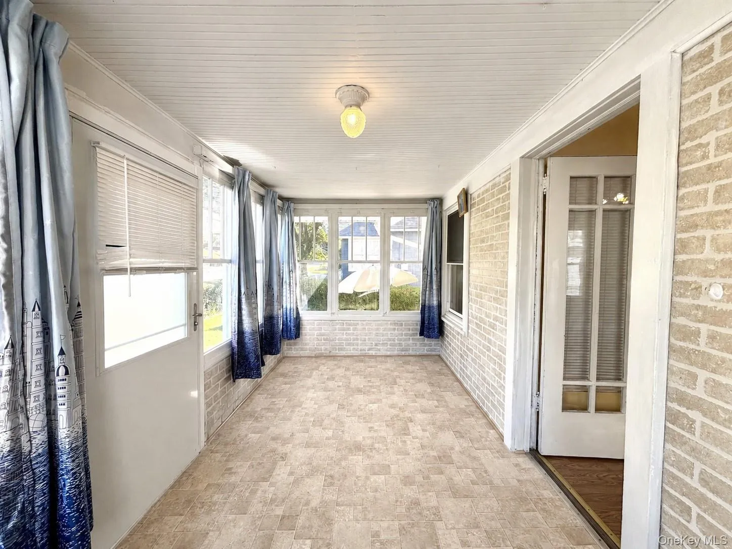 Bright enclosed sunroom with abundant natural light. Bright enclosed sunroom with abundant natural light.