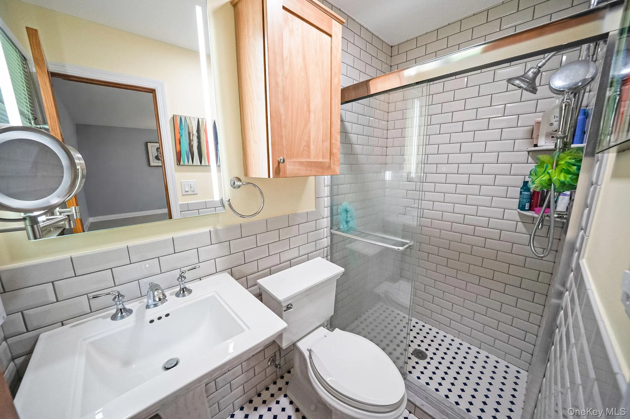 White subway tile shower enclosure with a glass shower door White subway tile shower enclosure with a glass shower door