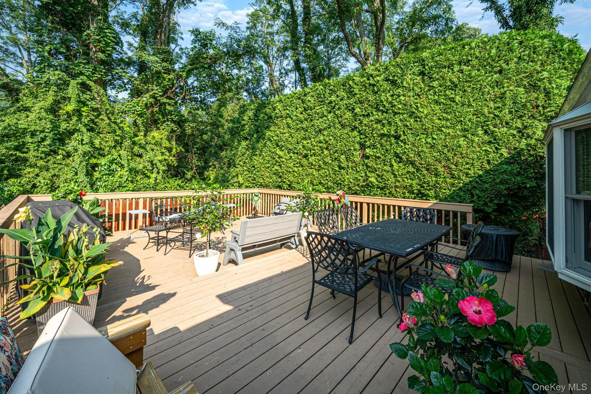 Expansive wood-finish deck with multiple levels, featuring a wood railing system Expansive wood-finish deck with multiple levels, featuring a wood railing system