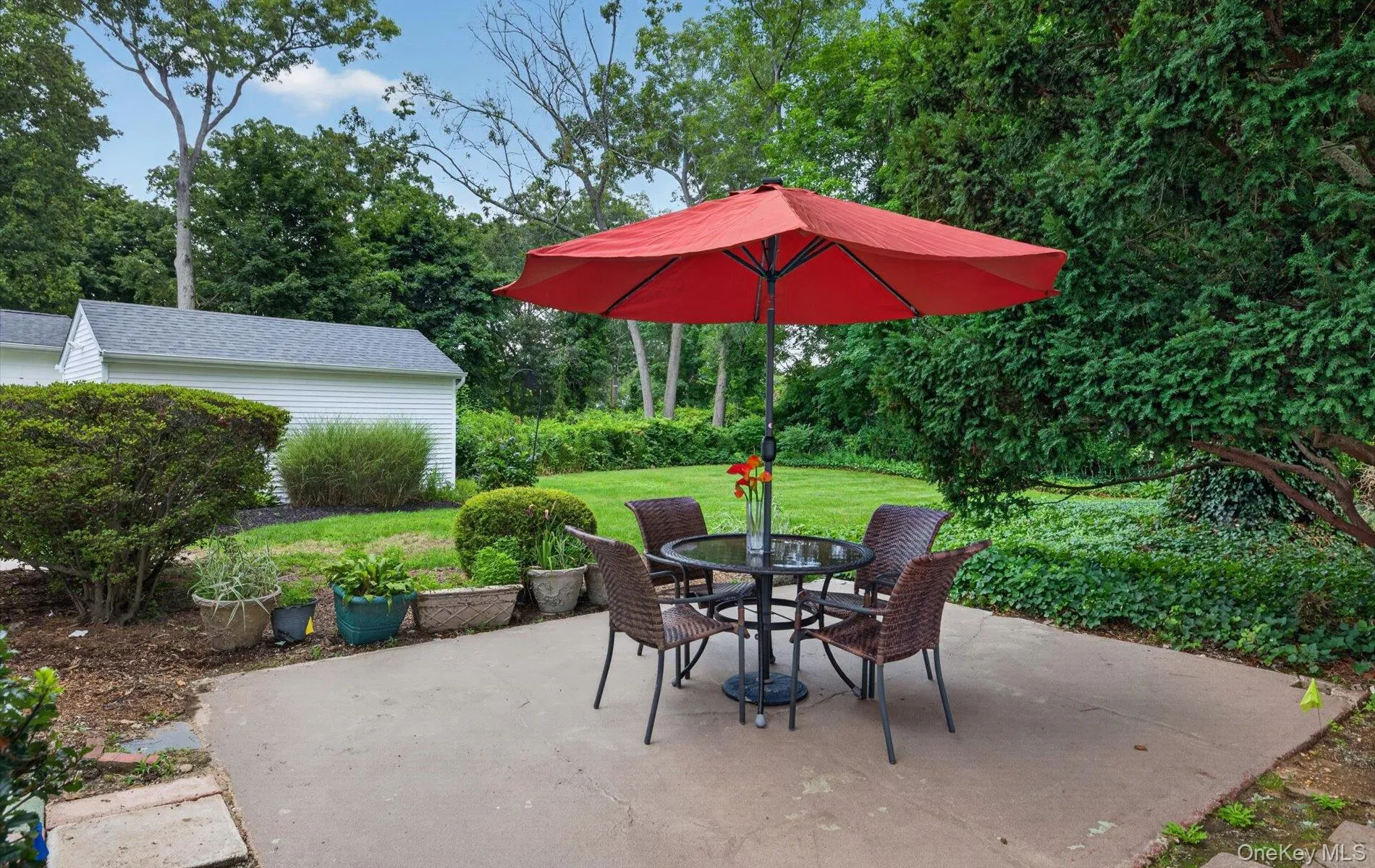 Expansive concrete patio offering a dedicated outdoor area Expansive concrete patio offering a dedicated outdoor area