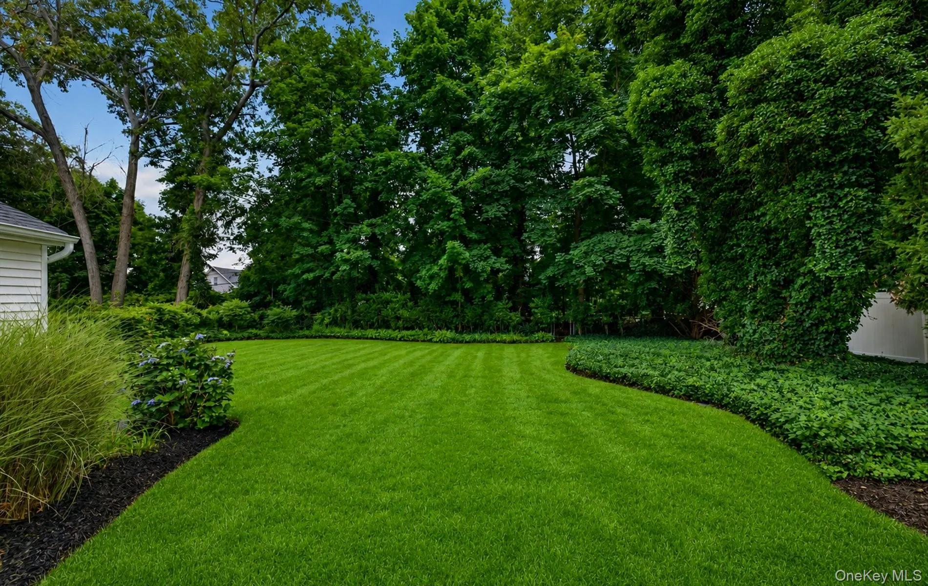 Expansive lawn area featuring neat striping and mature perimeter trees Expansive lawn area featuring neat striping and mature perimeter trees