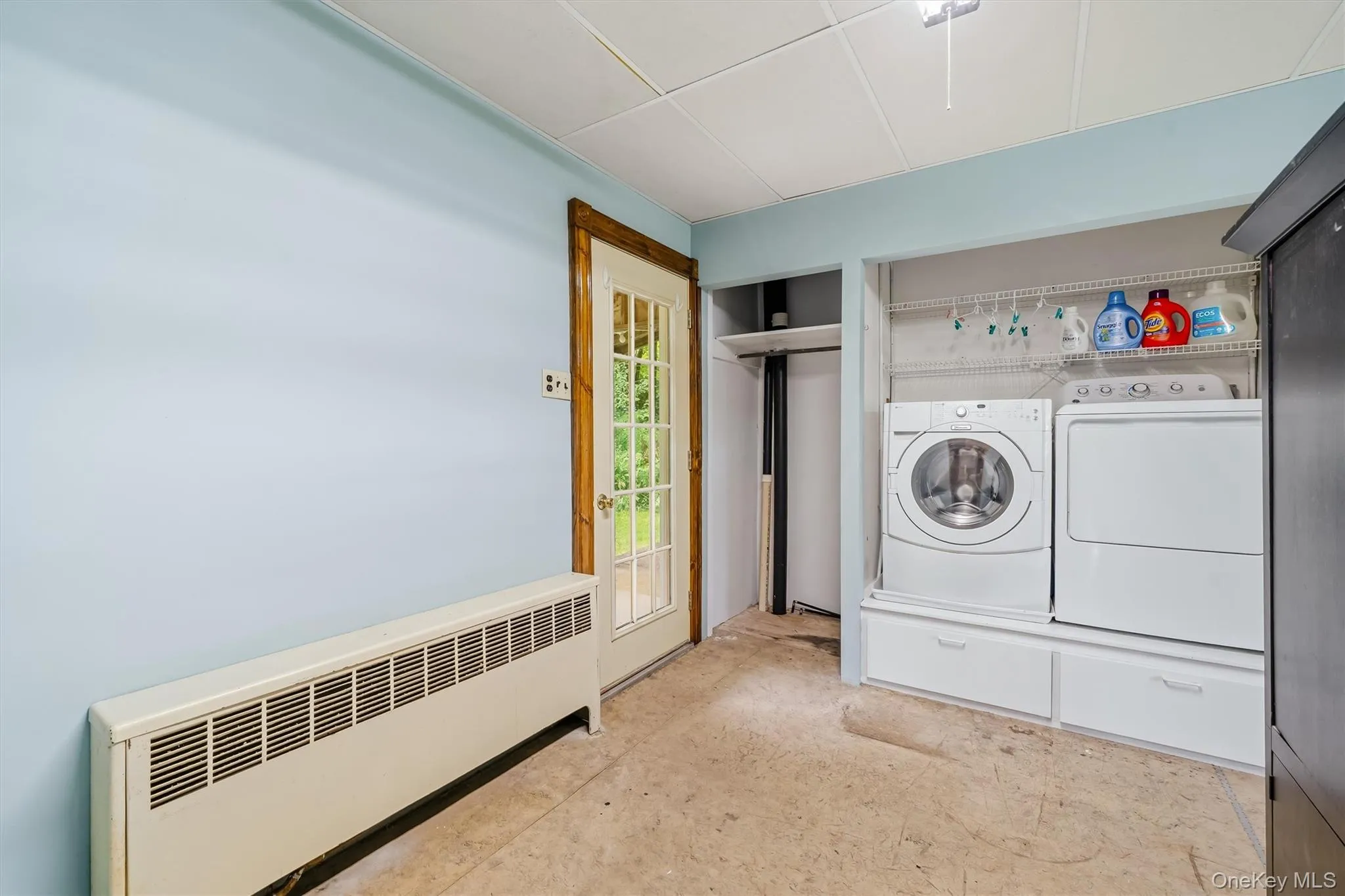 laundry area with door access to side porch laundry area with door access to side porch