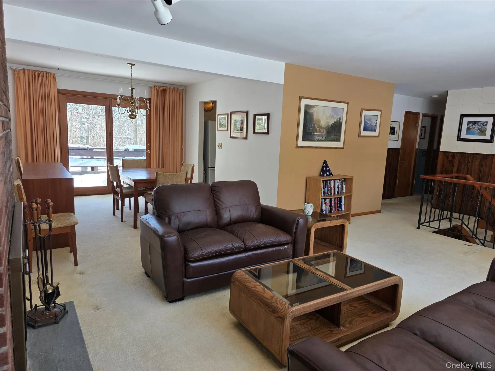 Living room with view of dining area with sliders to deck. Living room with view of dining area with sliders to deck.