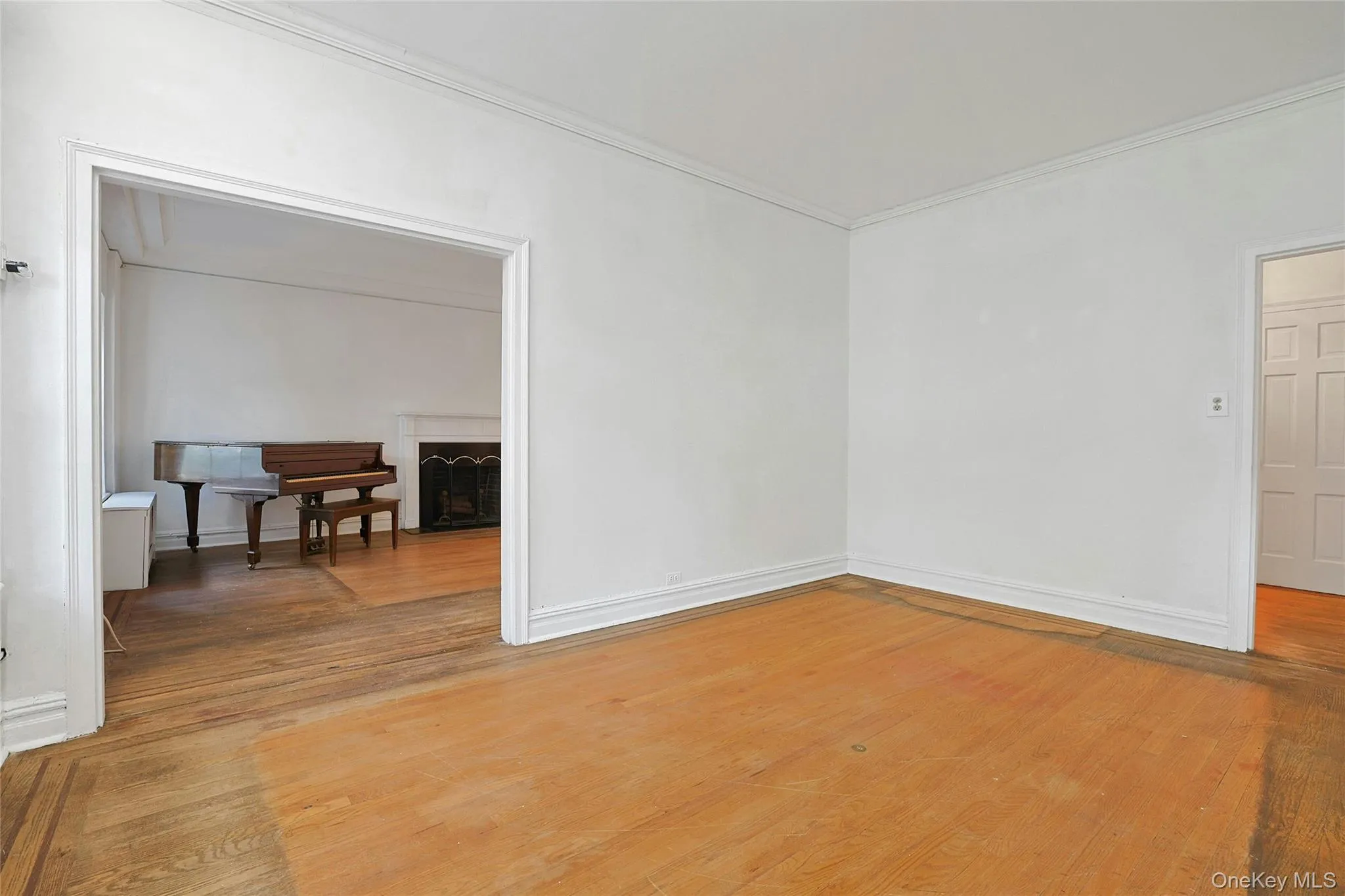 Spacious formal dining room with hardwood floors and an open view into the adjoining living room. Spacious formal dining room with hardwood floors and an open view into the adjoining living room.