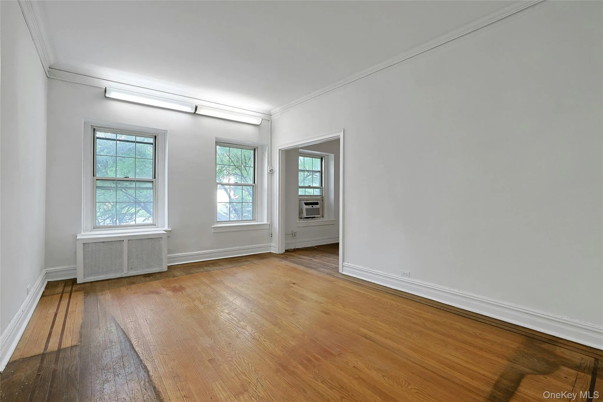 Bright formal dining room with hardwood floors, multiple windows, and generous proportions. Bright formal dining room with hardwood floors, multiple windows, and generous proportions.