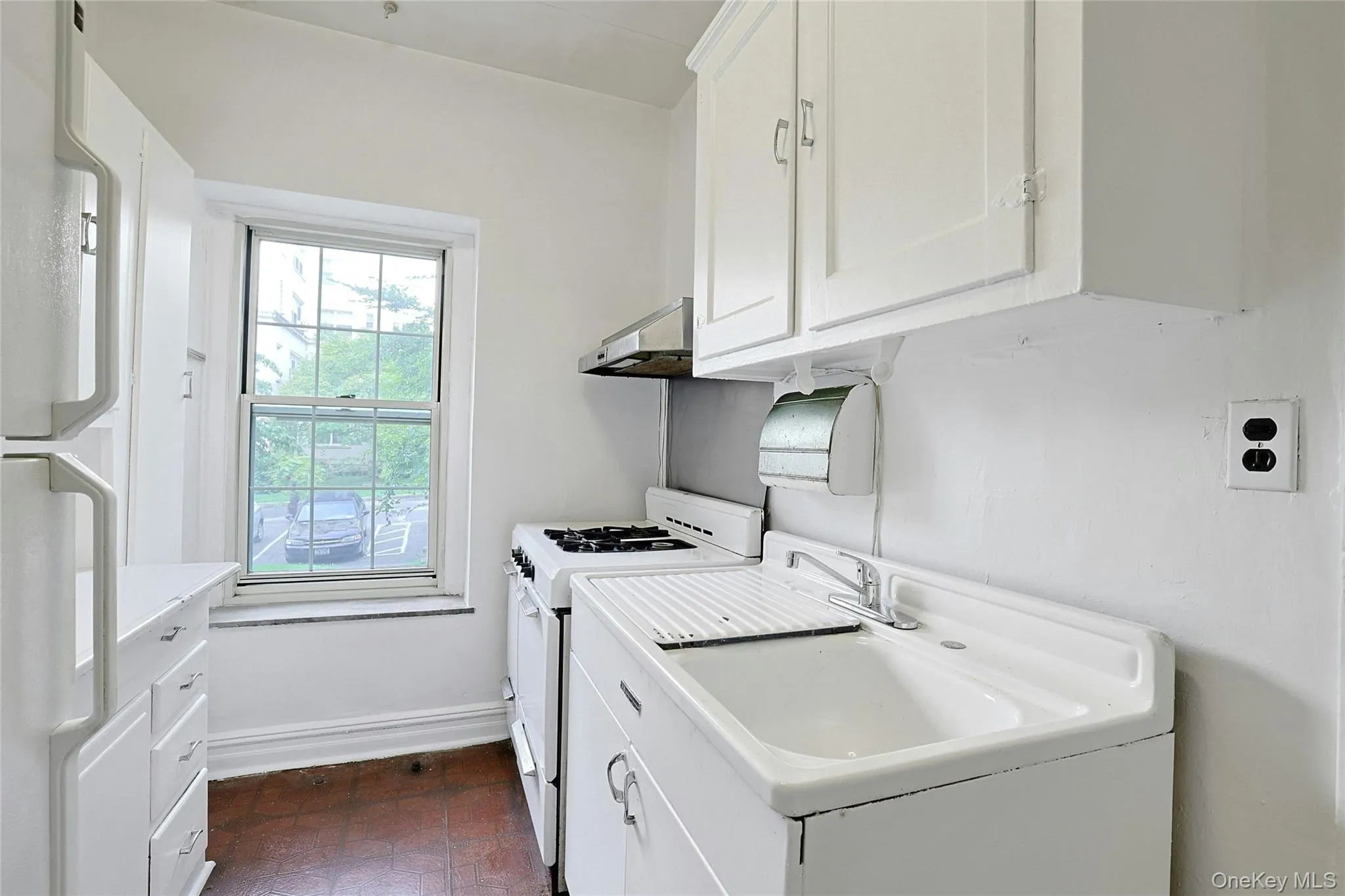 Additional view of the windowed kitchen with generous cabinetry and counter space. Additional view of the windowed kitchen with generous cabinetry and counter space.
