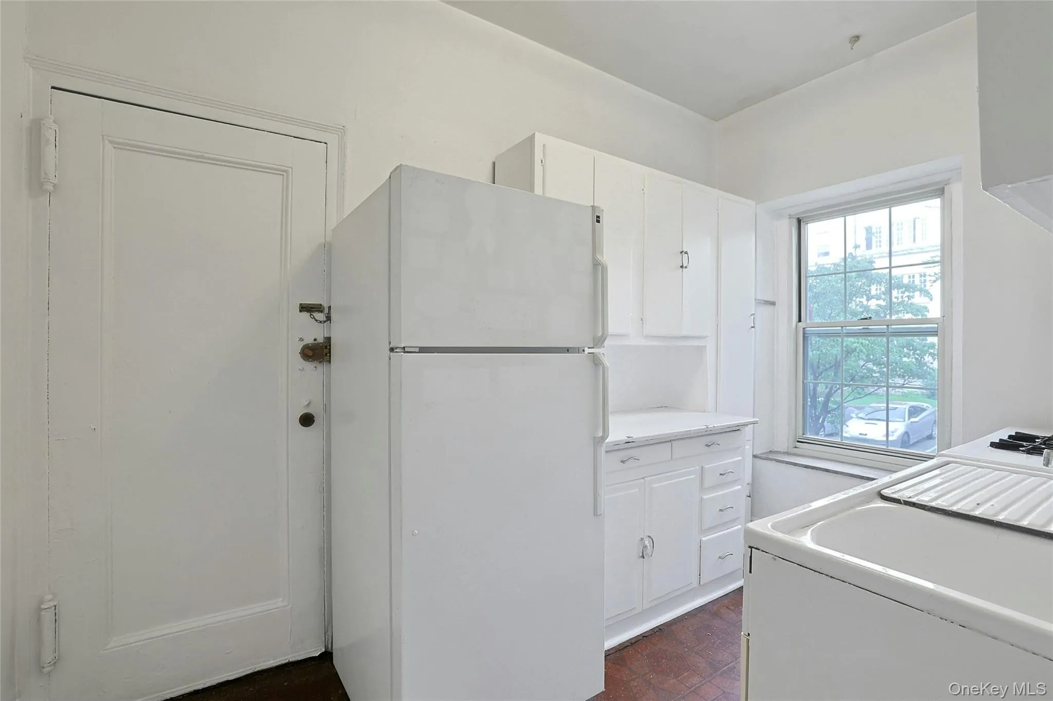 Windowed kitchen offering ample cabinetry, workspace, and natural light. Windowed kitchen offering ample cabinetry, workspace, and natural light.