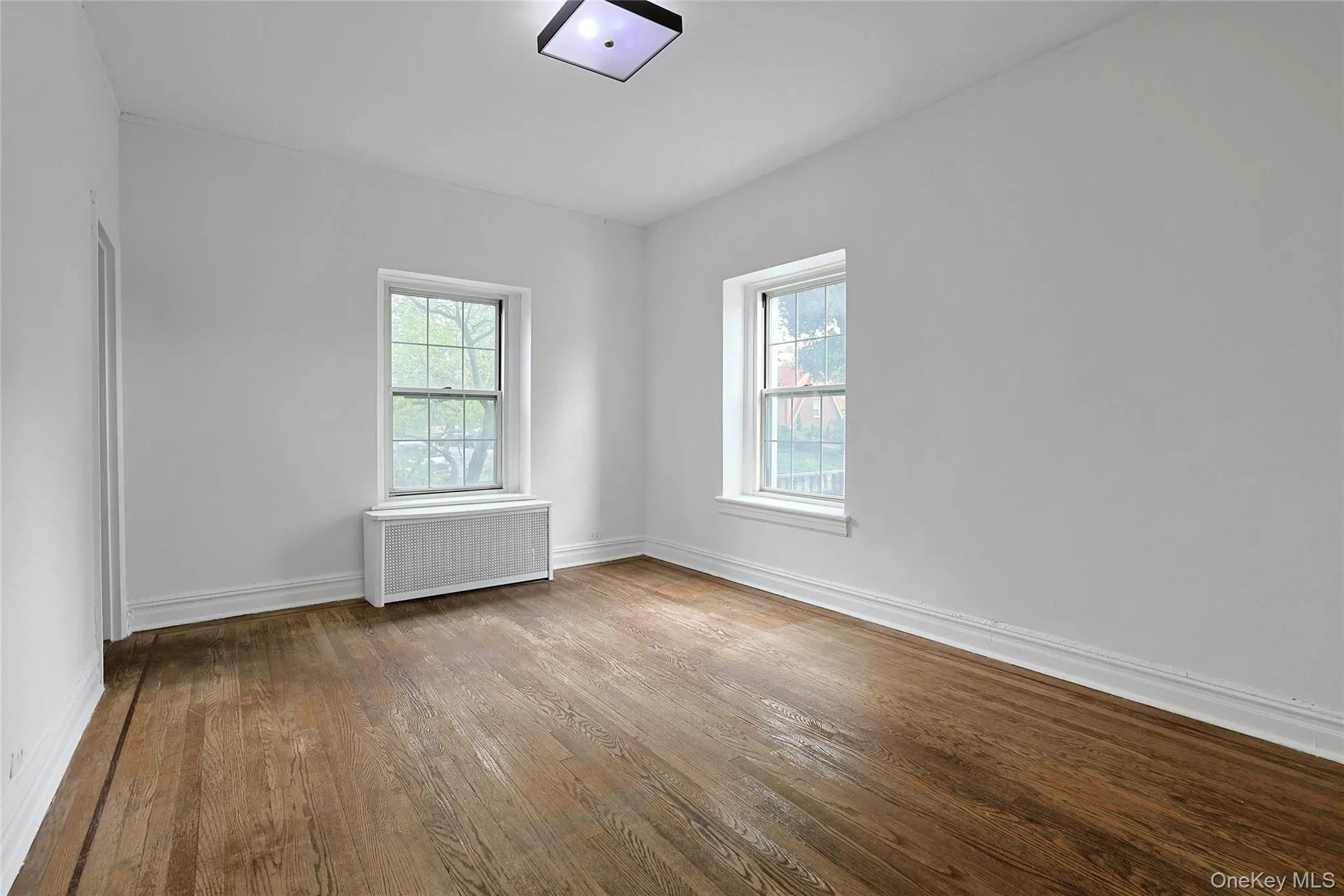 Spacious primary bedroom with multiple exposures, hardwood floors, and excellent natural light. Spacious primary bedroom with multiple exposures, hardwood floors, and excellent natural light.