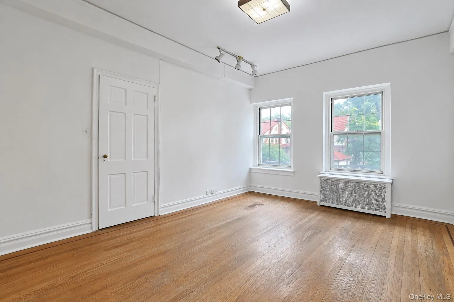 Bright and well-proportioned second bedroom featuring hardwood floors and two windows. Bright and well-proportioned second bedroom featuring hardwood floors and two windows.