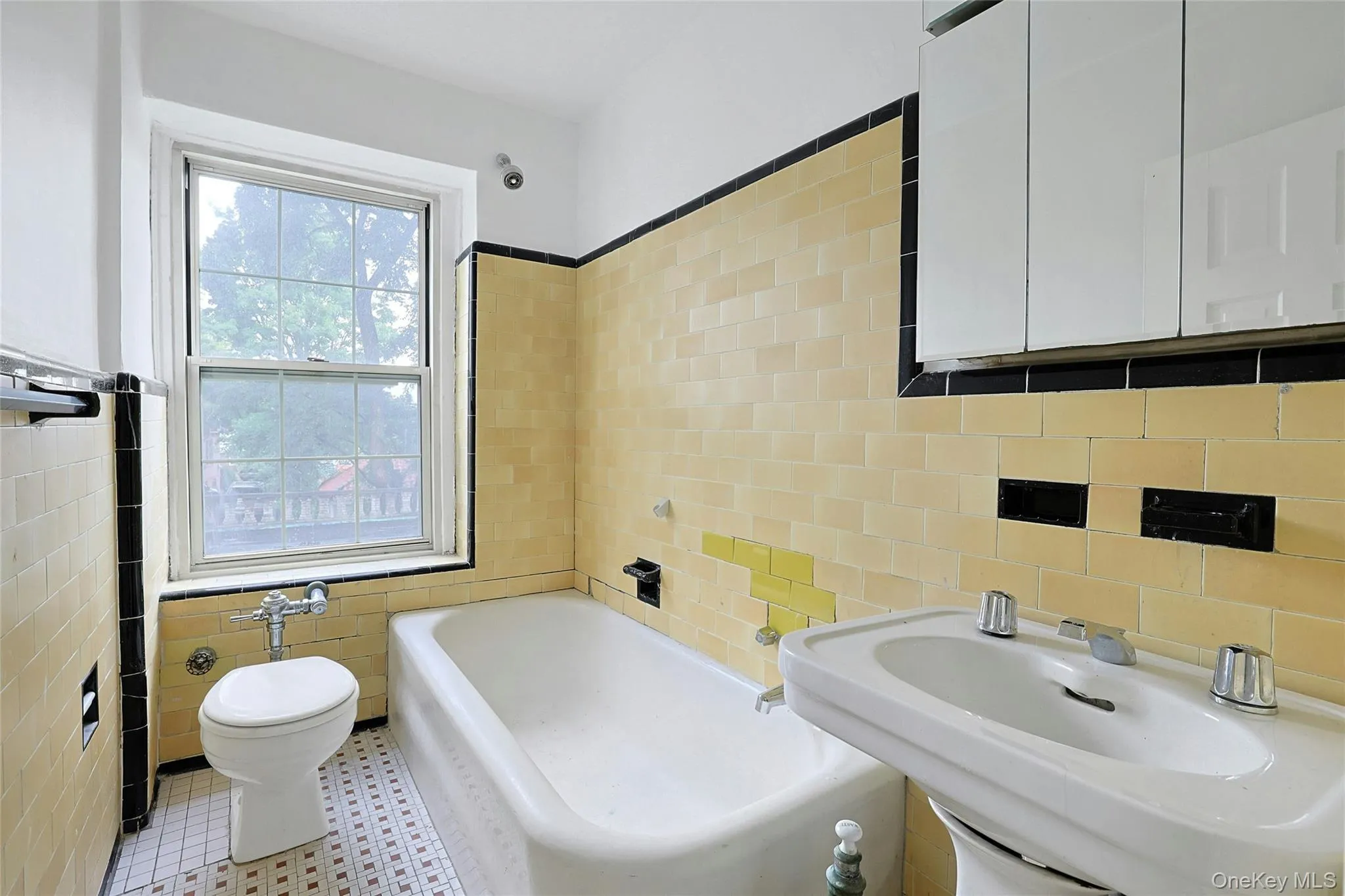 Windowed full bathroom with a tub and shower combination. Windowed full bathroom with a tub and shower combination.