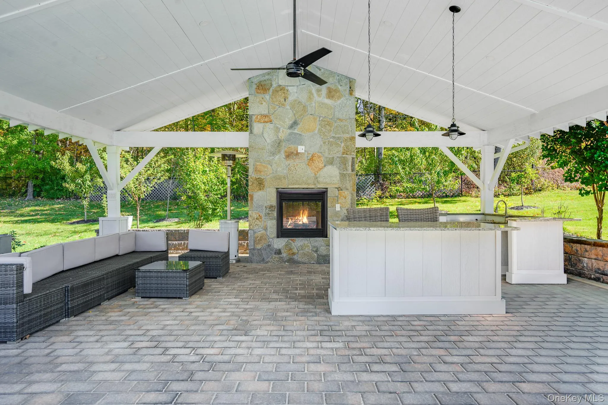 Outdoor covered pavillion with a central island, sink and propane fireplace. Outdoor covered pavillion with a central island, sink and propane fireplace.
