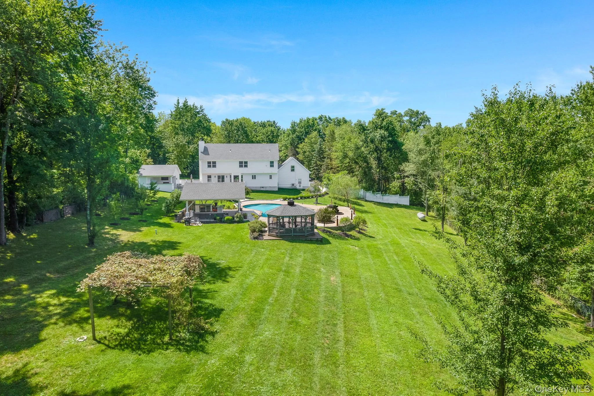 The backyard also features a fire-pit, gazebo, established grapevines, and fruit trees. The backyard also features a fire-pit, gazebo, established grapevines, and fruit trees.