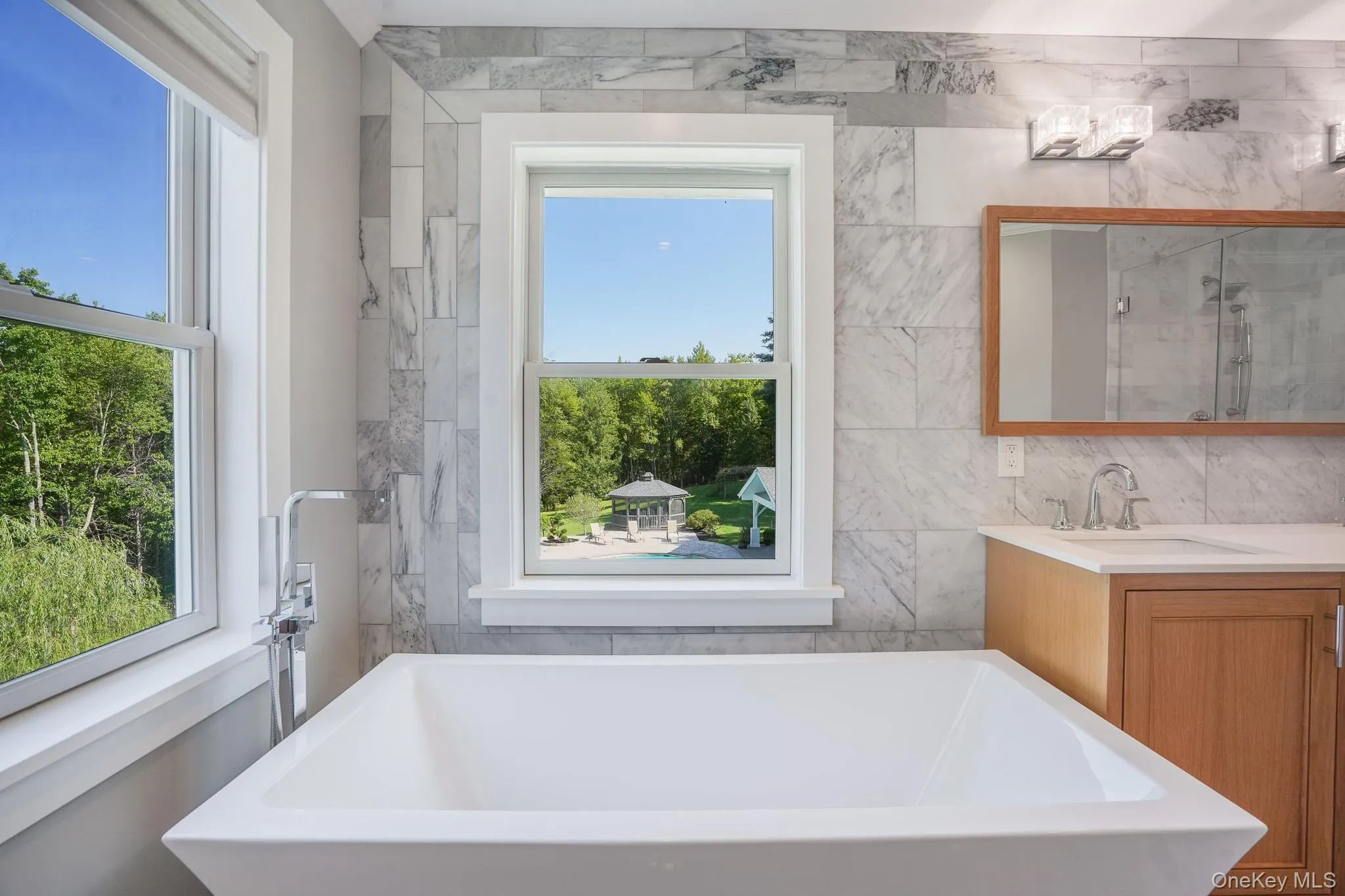 Soaking tub in the master bathroom with views of the backyard. Soaking tub in the master bathroom with views of the backyard.