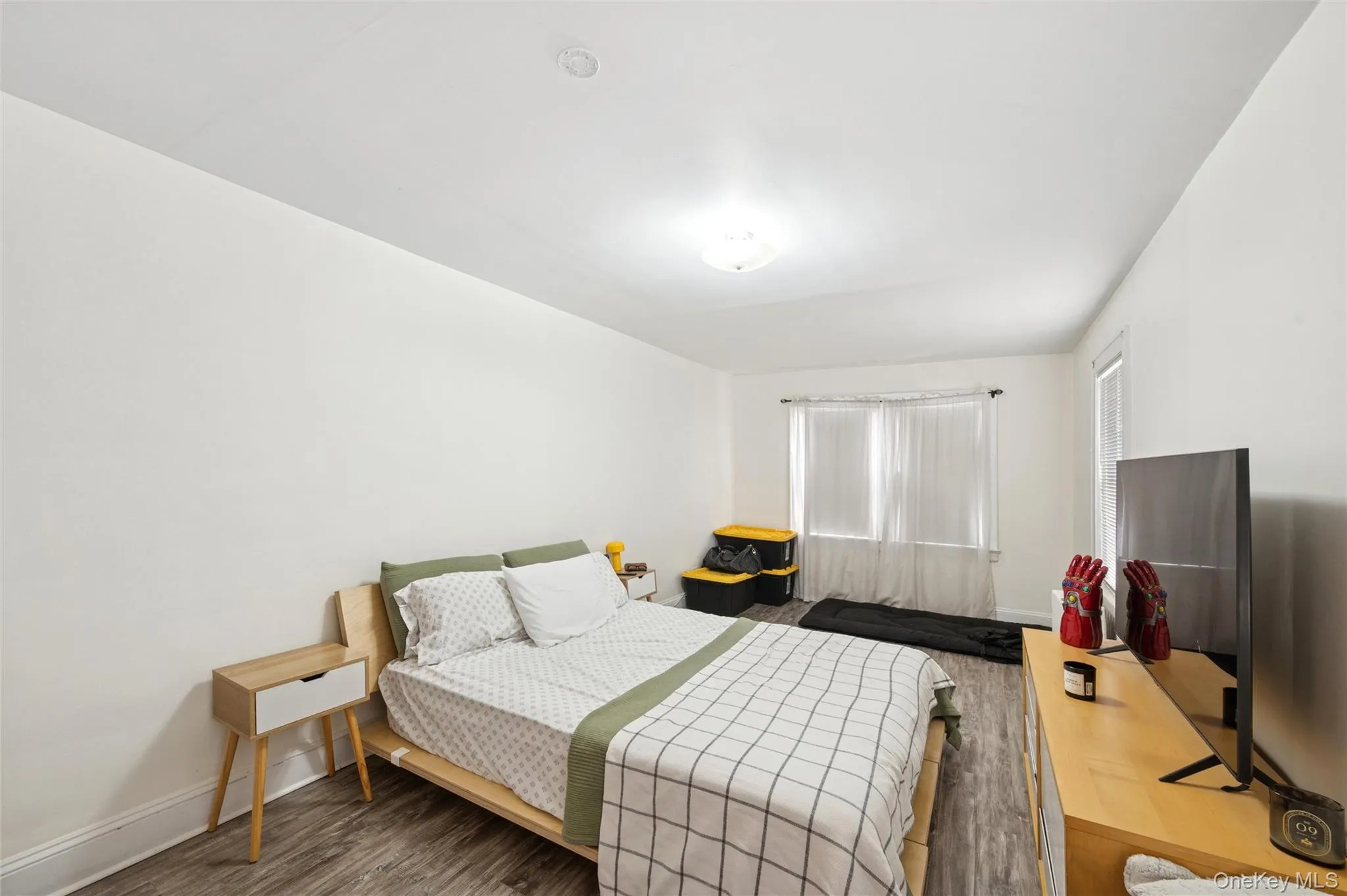 Bedroom with wood finished floors and baseboards Bedroom with wood finished floors and baseboards