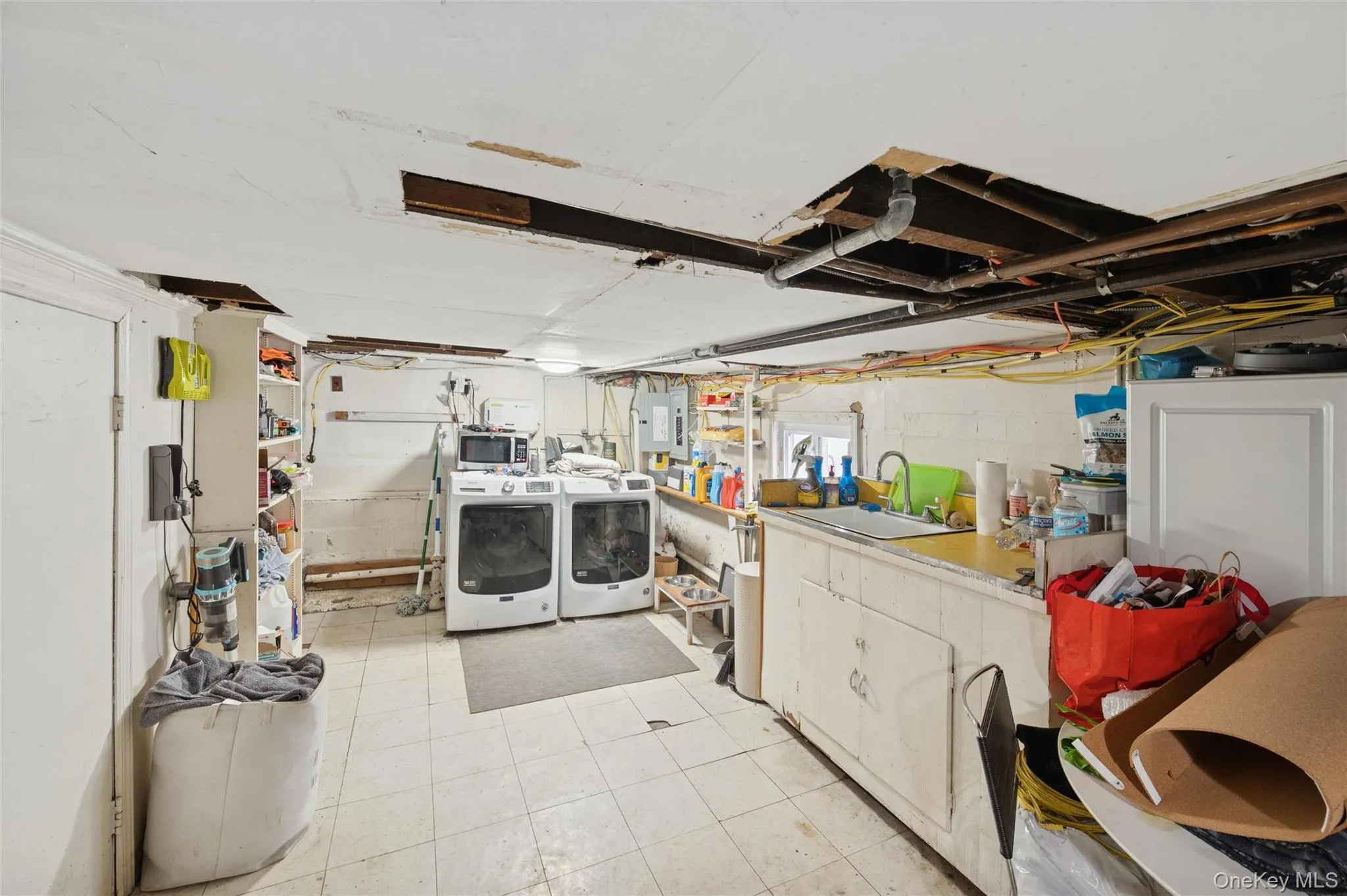 Laundry room featuring washing machine and clothes dryer and electric panel Laundry room featuring washing machine and clothes dryer and electric panel