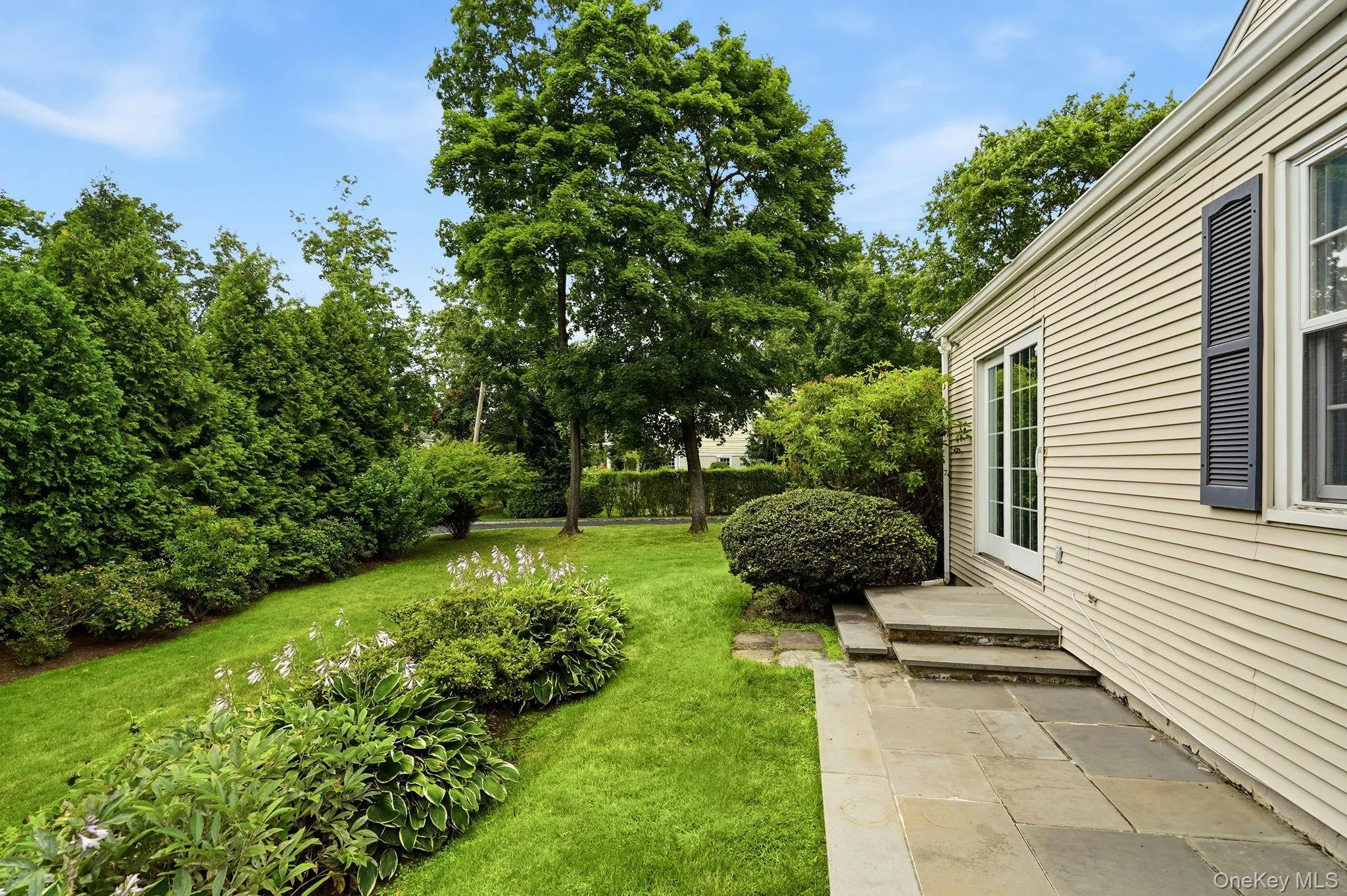 Beautiful Landscaped side property with patio off the kitchen Beautiful Landscaped side property with patio off the kitchen
