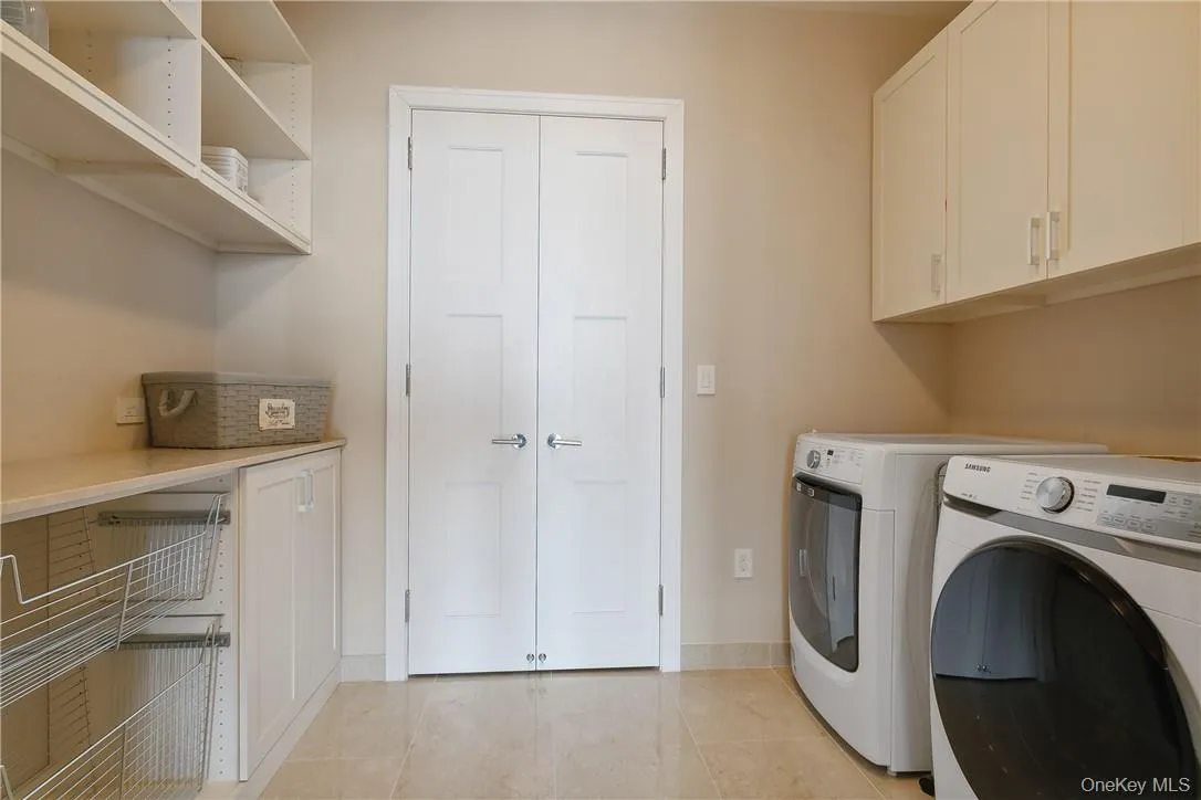 Laundry room with storage closet and shelving Laundry room with storage closet and shelving