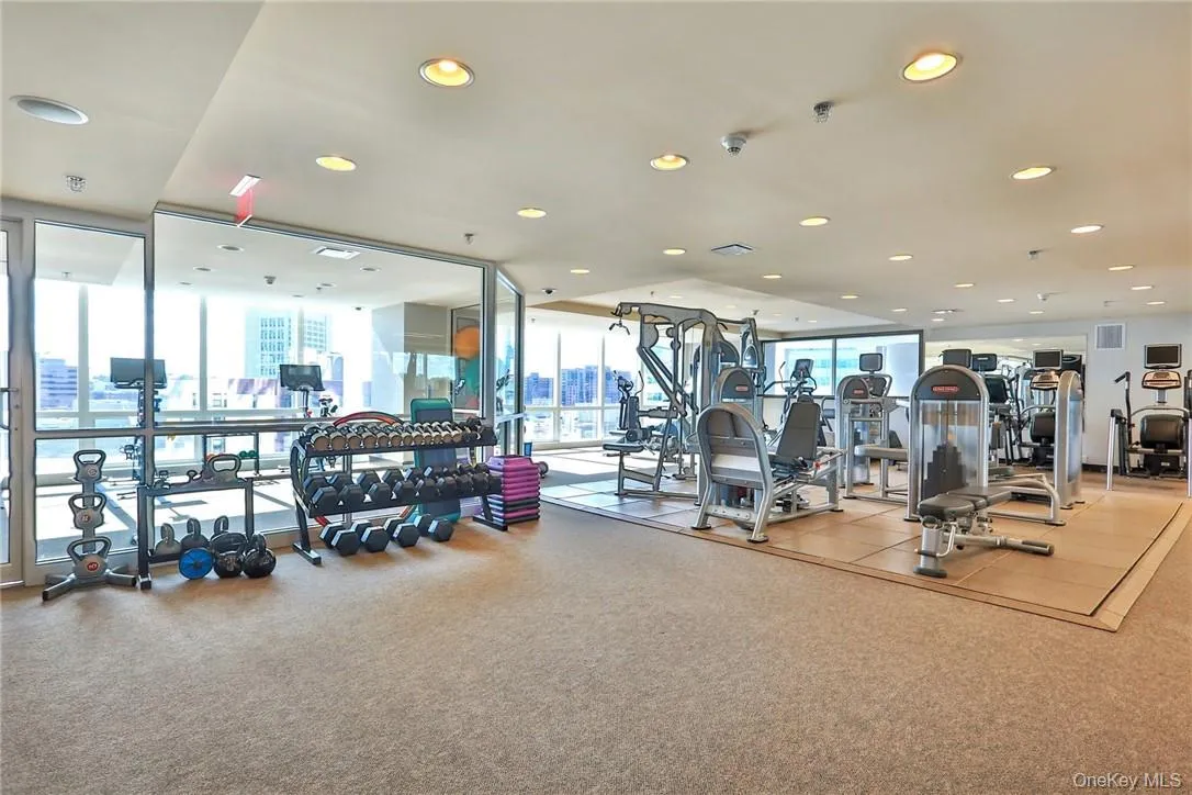 Gym featuring a wall of windows and a wealth of natural light Gym featuring a wall of windows and a wealth of natural light