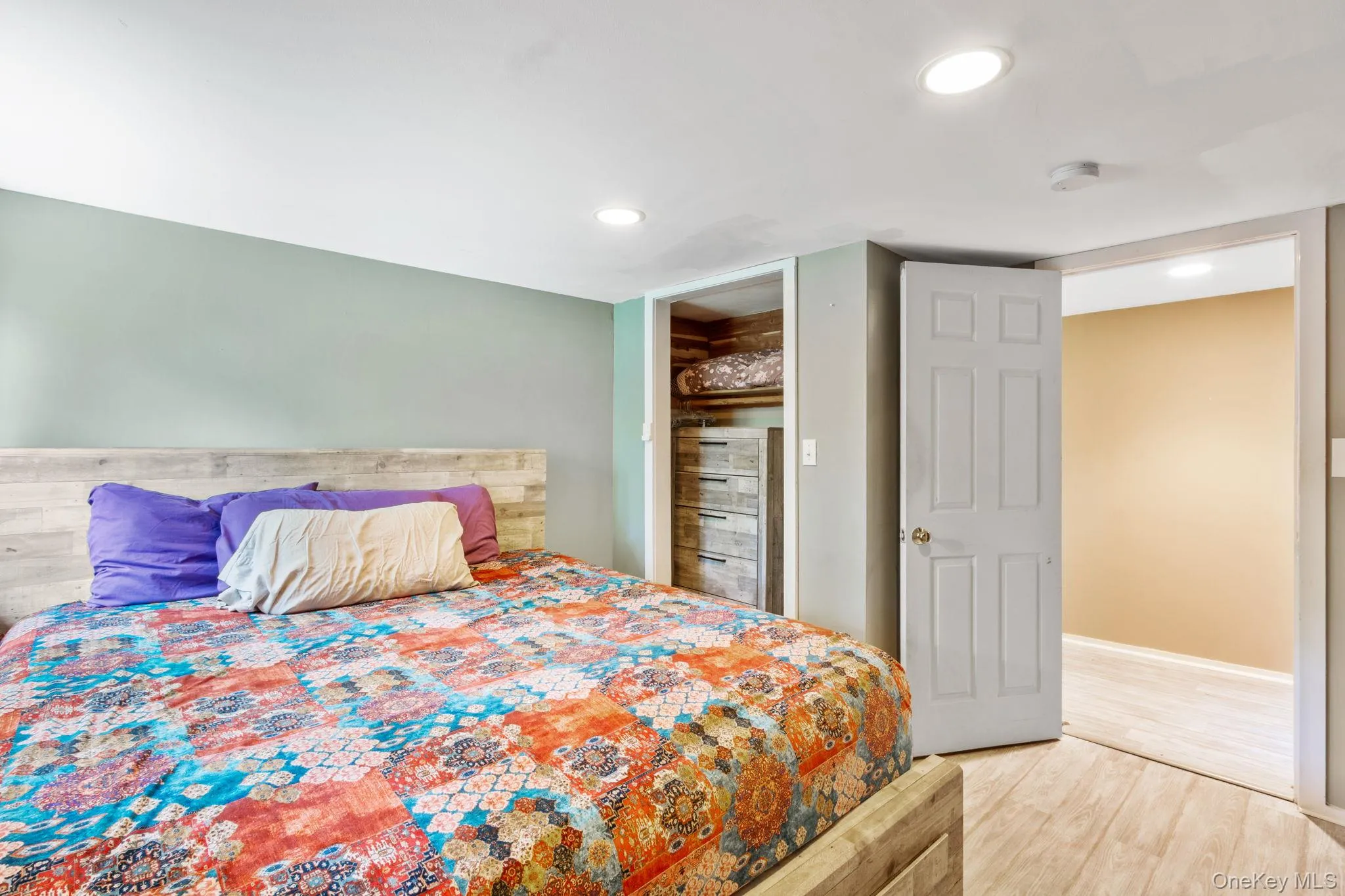 The first of two cozy bedrooms located on the main level, featuring peaceful forest views. The first of two cozy bedrooms located on the main level, featuring peaceful forest views.