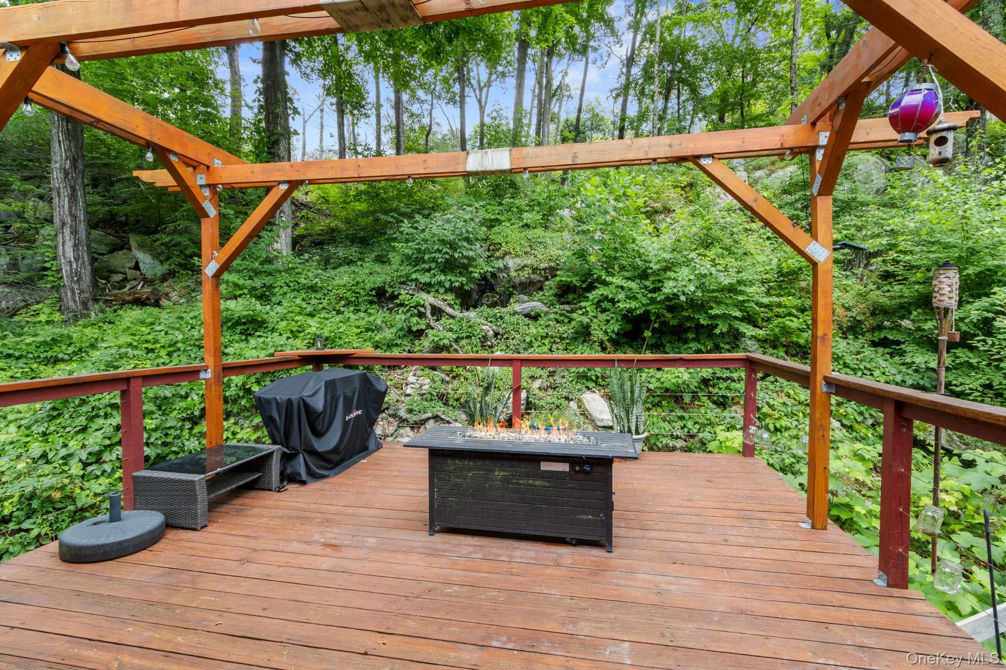 Serene deck surrounded by lush woods, perfect for barbecuing or spending time with friends and family. Serene deck surrounded by lush woods, perfect for barbecuing or spending time with friends and family.