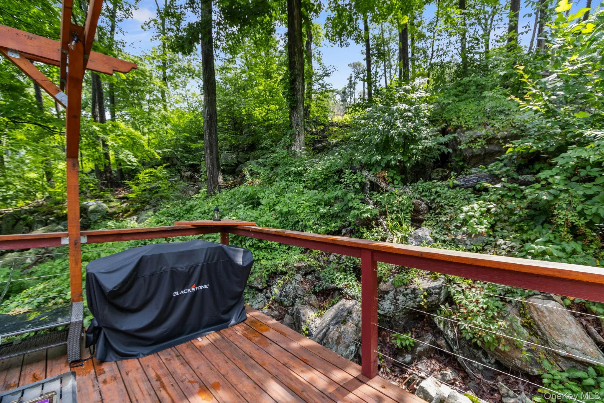 Serene deck surrounded by lush woods, perfect for barbecuing or spending time with friends and family. Serene deck surrounded by lush woods, perfect for barbecuing or spending time with friends and family.