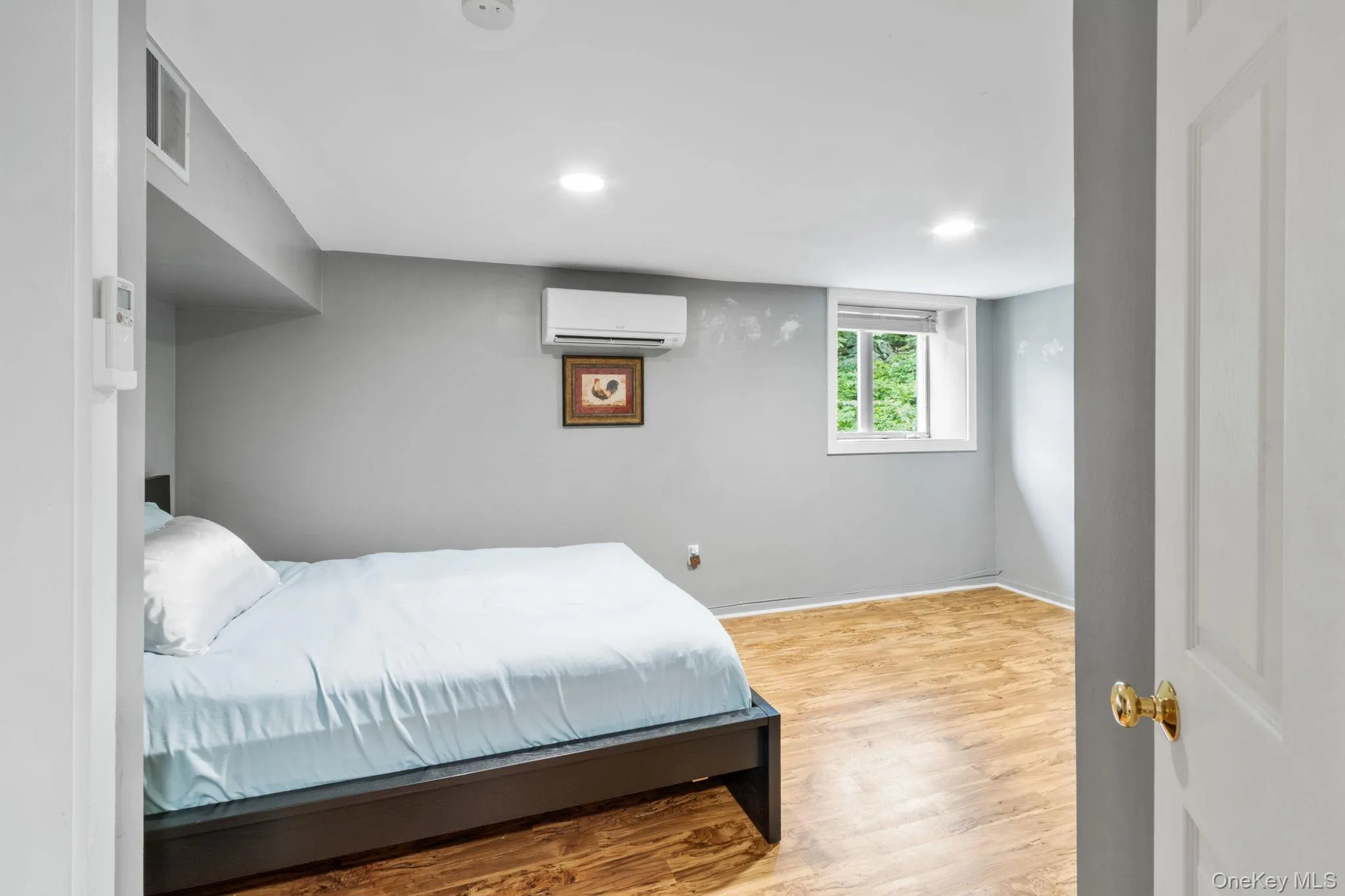 The second of two cozy bedrooms located on the main level, featuring peaceful forest views. The second of two cozy bedrooms located on the main level, featuring peaceful forest views.