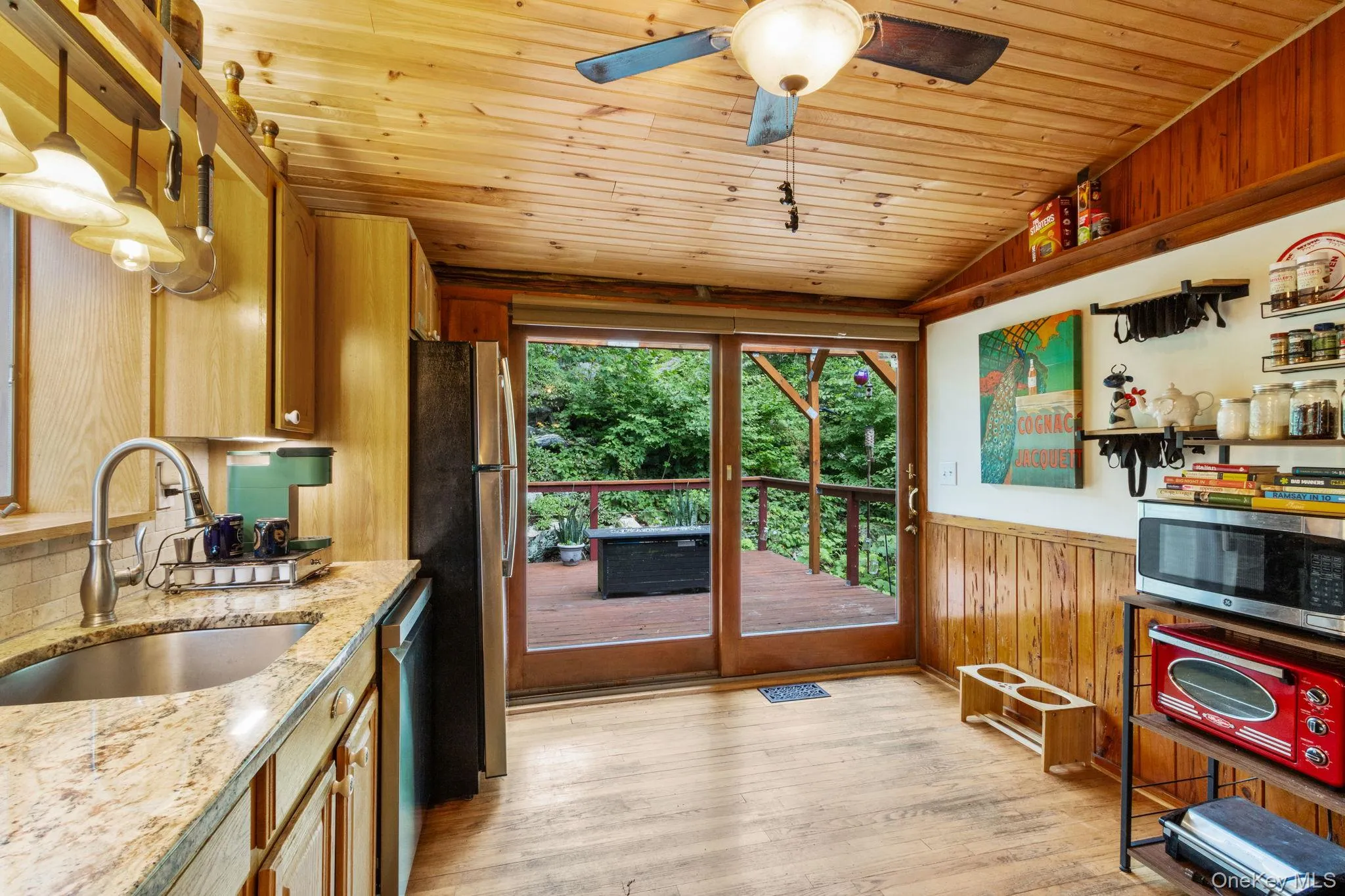 Large sliding glass doors lead directly from the kitchen to the deck, creating the perfect setup for barbecuing and outdoor entertaining. Large sliding glass doors lead directly from the kitchen to the deck, creating the perfect setup for barbecuing and outdoor entertaining.
