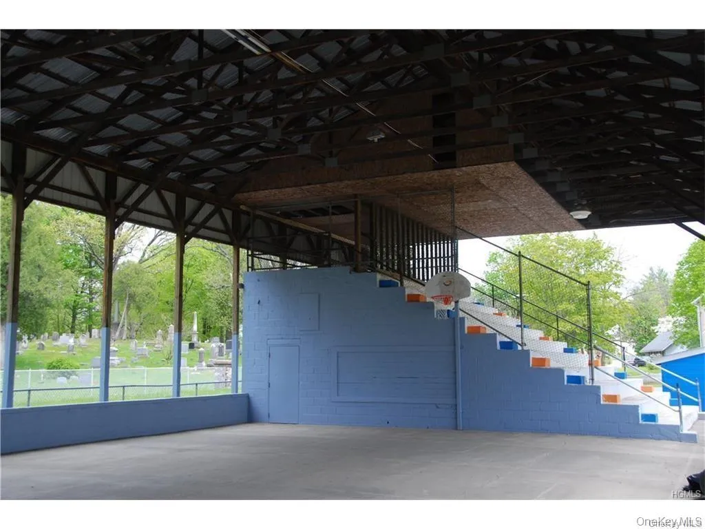 The covered pavilion has seats to watch the ball game (see bleechers at back of photo), basketball hoops, and a large open space perfect for learning to ride a bike! The covered pavilion has seats to watch the ball game (see bleechers at back of photo), basketball hoops, and a large open space perfect for learning to ride a bike!