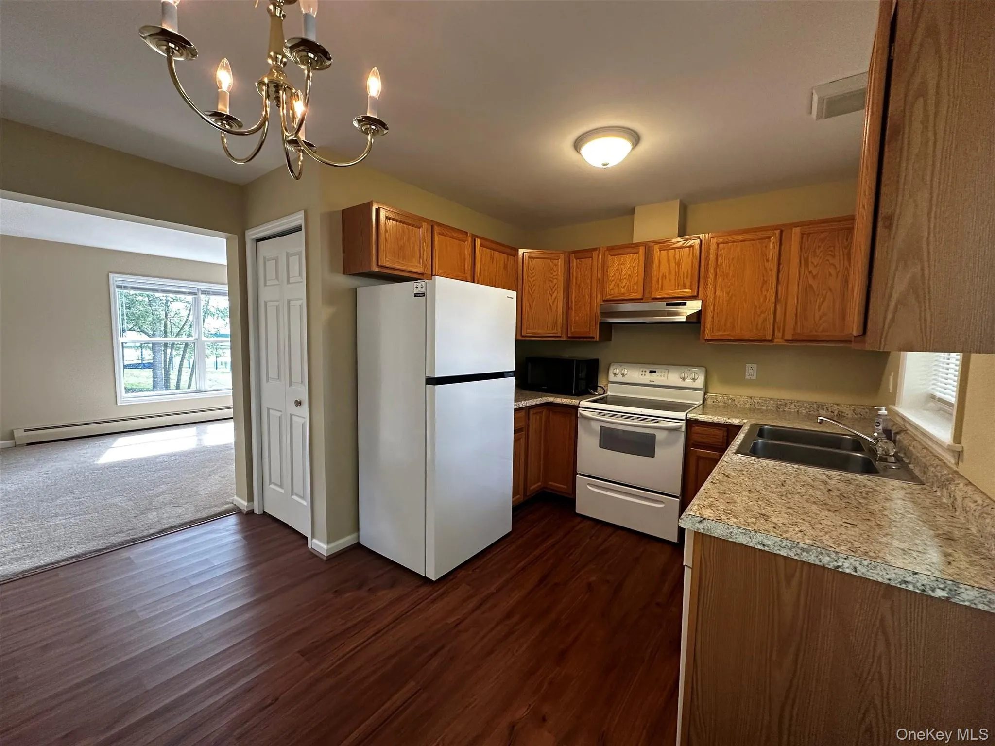 The kitchen is clean and well equipped with all of the key appliances including a dishwasher! The refrigerator is brand new! Located off of the family room, perfect for grabbing a snack during movie night or entertaining some friends. The kitchen is clean and well equipped with all of the key appliances including a dishwasher! The refrigerator is brand new! Located off of the family room, perfect for grabbing a snack during movie night or entertaining some friends.