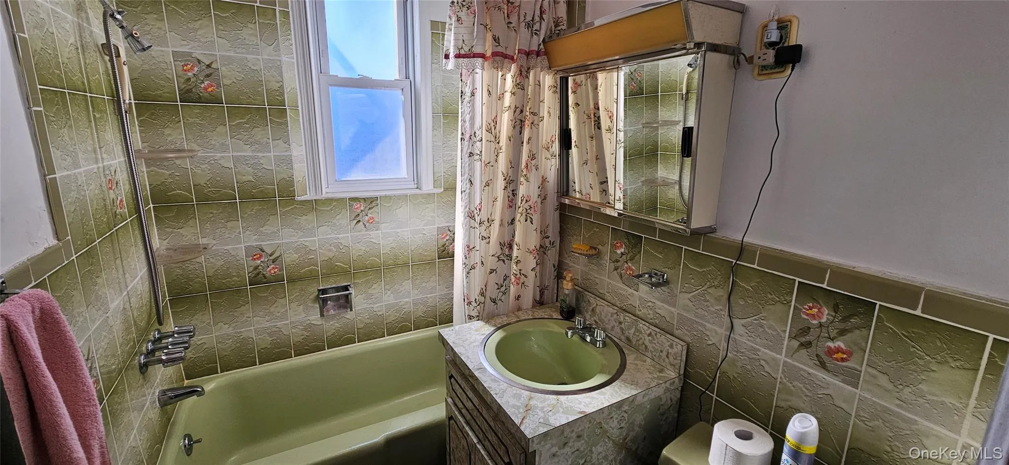 Bathroom with vanity, bathtub / shower combination, and decorative backsplash Bathroom with vanity, bathtub / shower combination, and decorative backsplash
