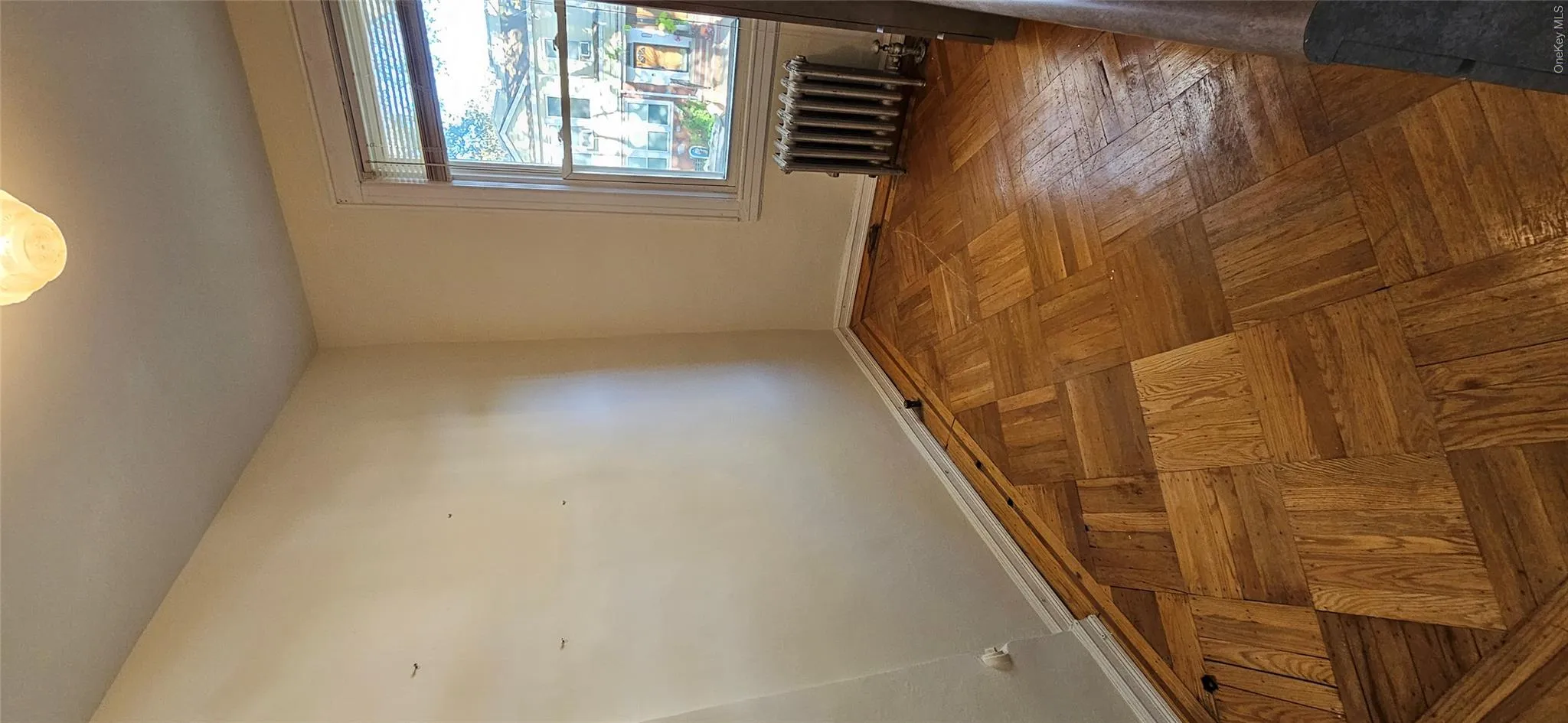 Unfurnished room with baseboards and radiator heating unit Unfurnished room with baseboards and radiator heating unit