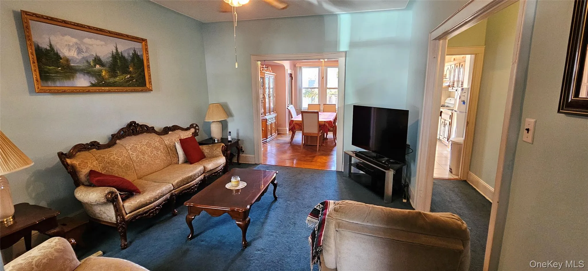 Living room with ceiling fan and baseboards Living room with ceiling fan and baseboards
