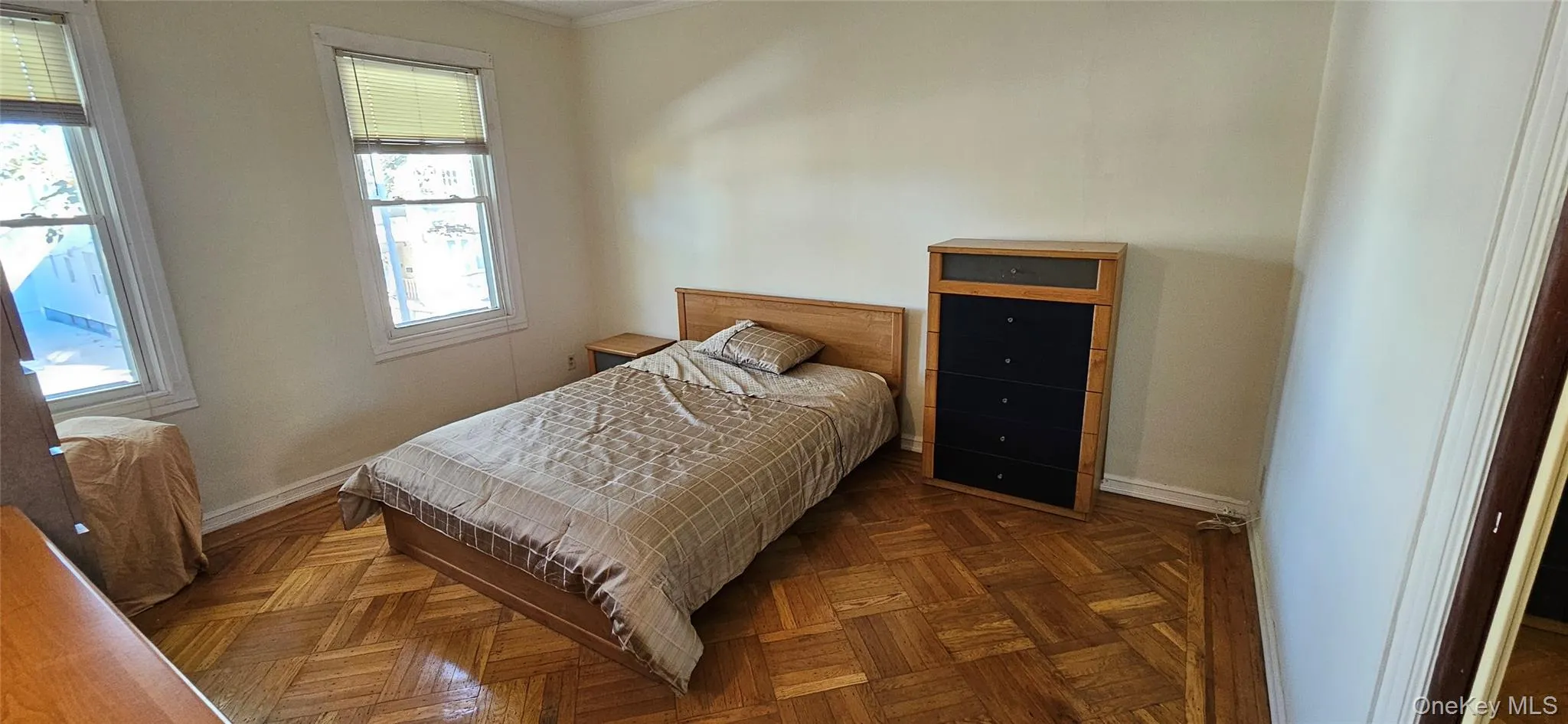 Bedroom featuring ornamental molding and baseboards Bedroom featuring ornamental molding and baseboards