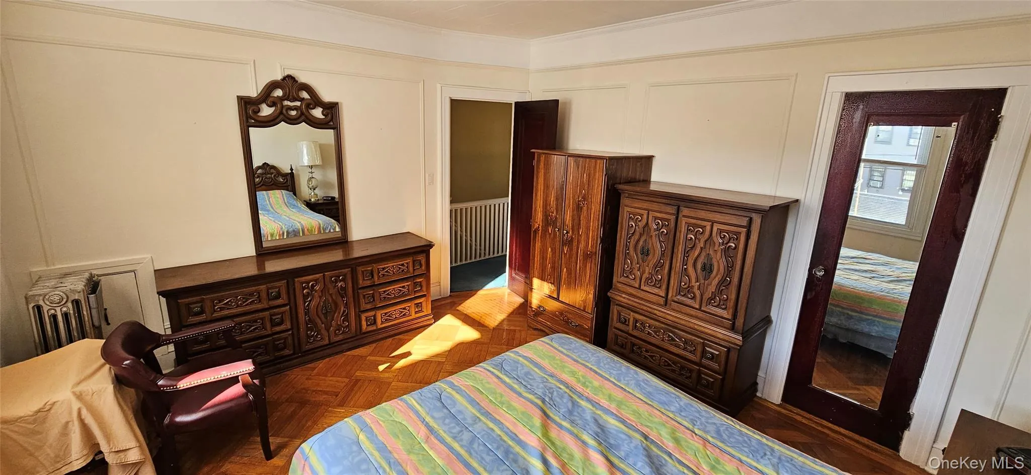 Bedroom with a decorative wall and ornamental molding Bedroom with a decorative wall and ornamental molding