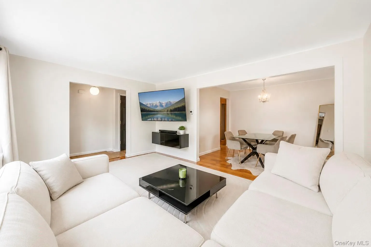 Living area featuring light-colored wall paint and carpet flooring Living area featuring light-colored wall paint and carpet flooring