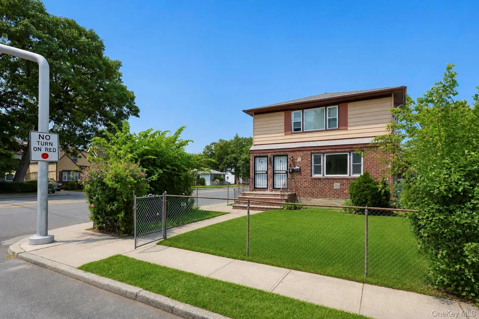 Two-story residence featuring a brick first level and siding second level Two-story residence featuring a brick first level and siding second level