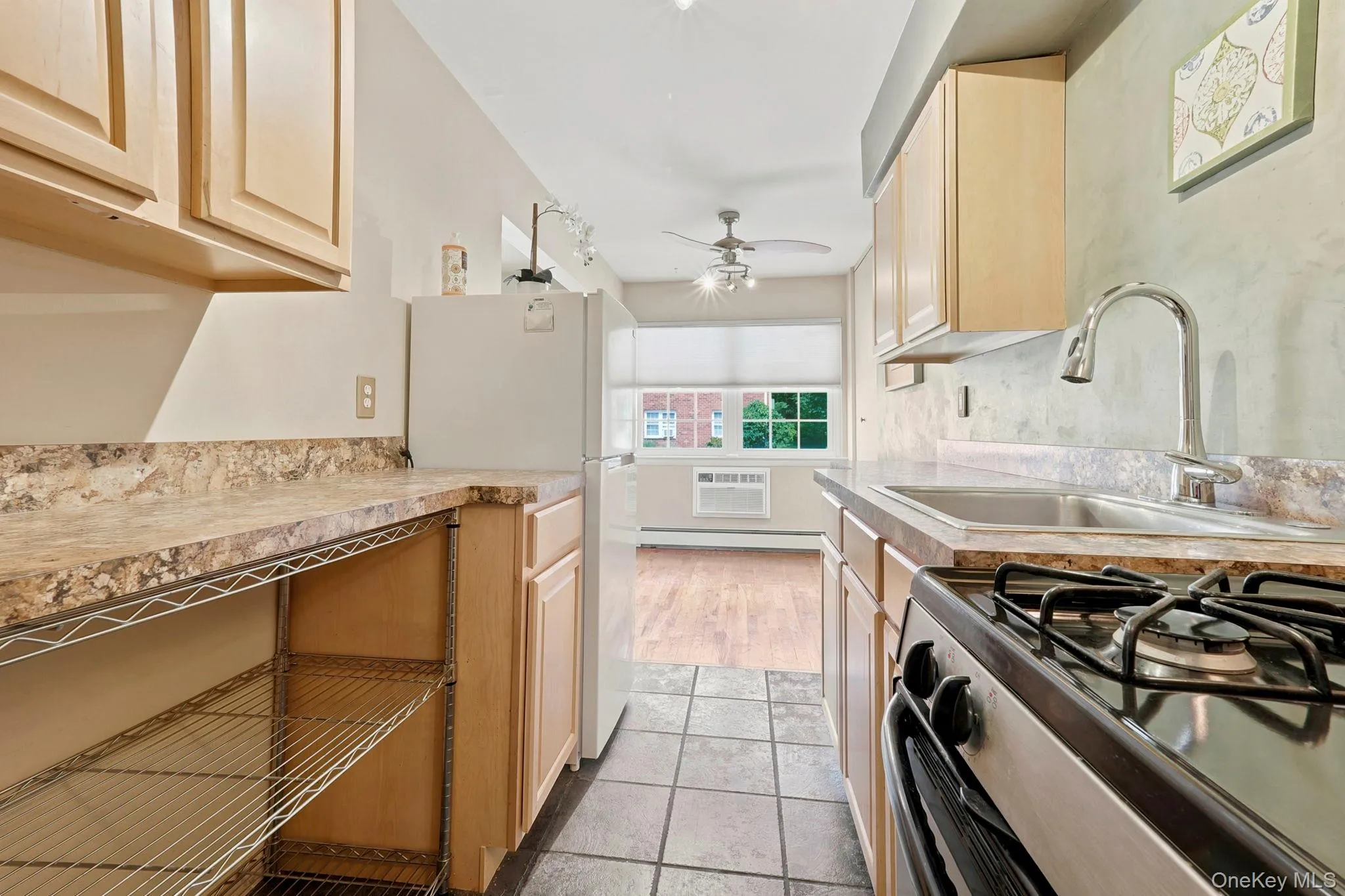 This efficient galley style kitchen has additional open shelving to maximize every area of storage. This efficient galley style kitchen has additional open shelving to maximize every area of storage.