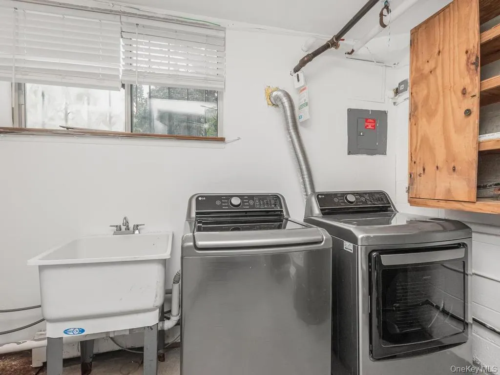 Stainless Steel Washer & Dryer & Laundry Tub in the basement. Photo may be AI Edited Stainless Steel Washer & Dryer & Laundry Tub in the basement. Photo may be AI Edited