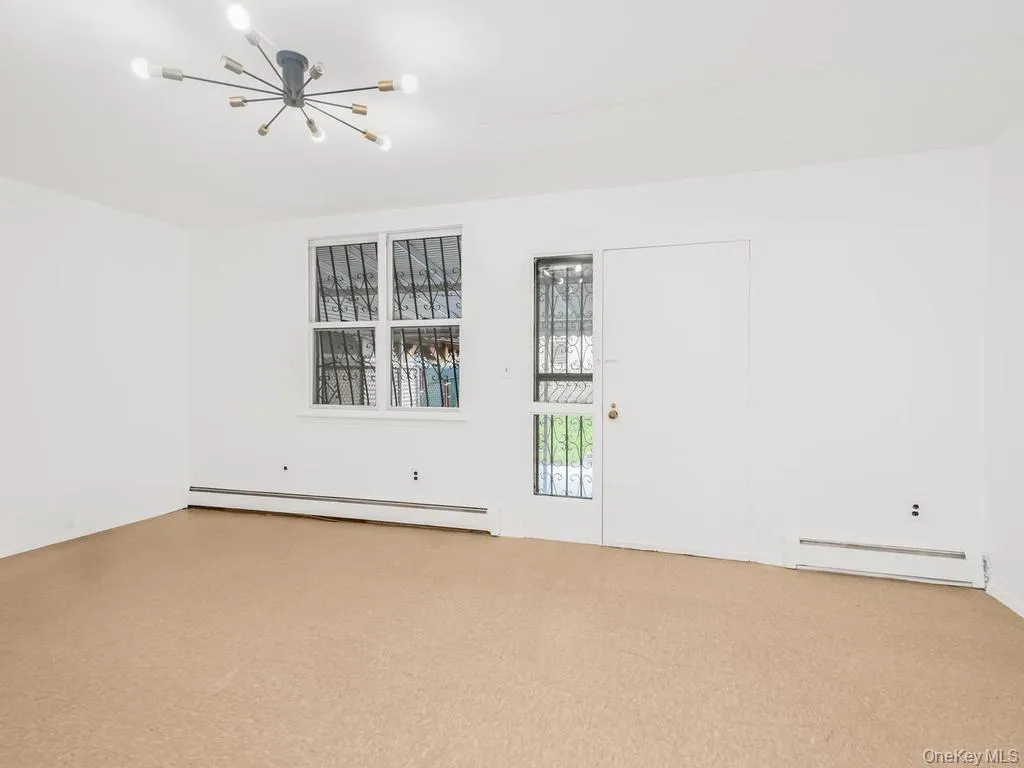 Living room with door to backyard. Photo may be AI Edited Living room with door to backyard. Photo may be AI Edited