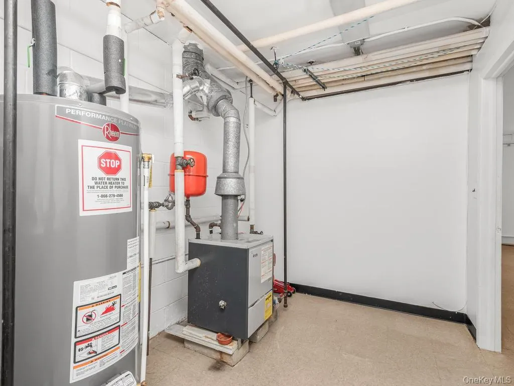Utility Room with Gas Boiler, hot water Heater. Photo may be AI Edited Utility Room with Gas Boiler, hot water Heater. Photo may be AI Edited