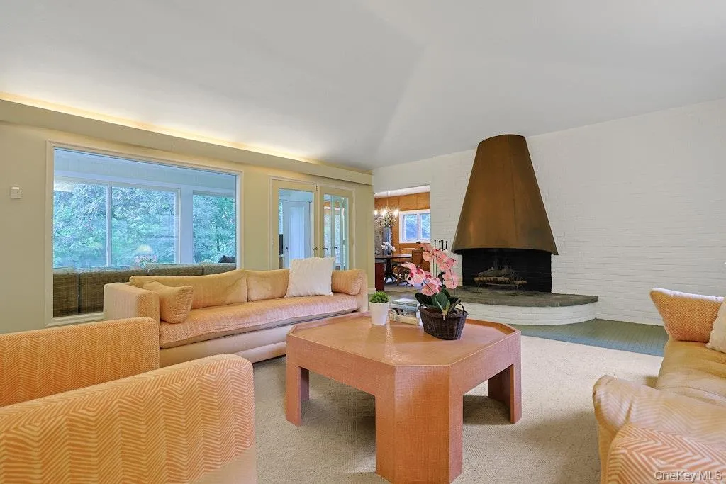 Spacious living room with oversized fireplace with copper hood Spacious living room with oversized fireplace with copper hood