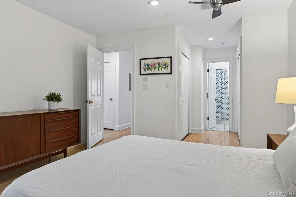 Wide hallway to primary bathroom with a large custom closet on both sides. Wide hallway to primary bathroom with a large custom closet on both sides.