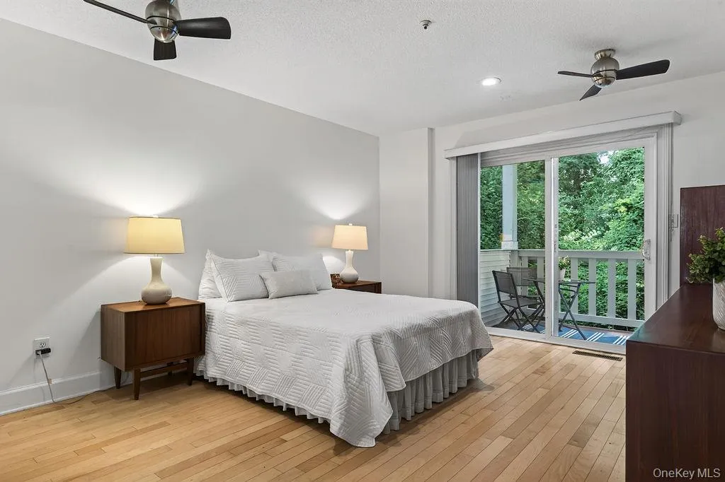 Very spacious bedroom suite with in the back with two ceiling fans and sliders to a peaceful deck. Very spacious bedroom suite with in the back with two ceiling fans and sliders to a peaceful deck.