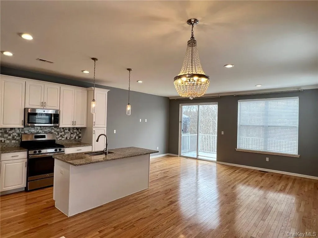 Shows kitchen, dining area and part of living room. Shows kitchen, dining area and part of living room.